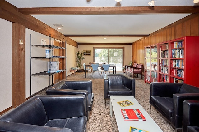 living room featuring beam ceiling, carpet flooring, and wood walls