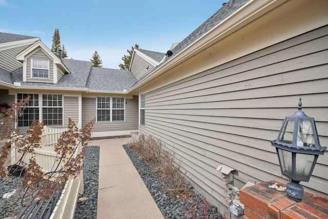 view of side of property with a shingled roof