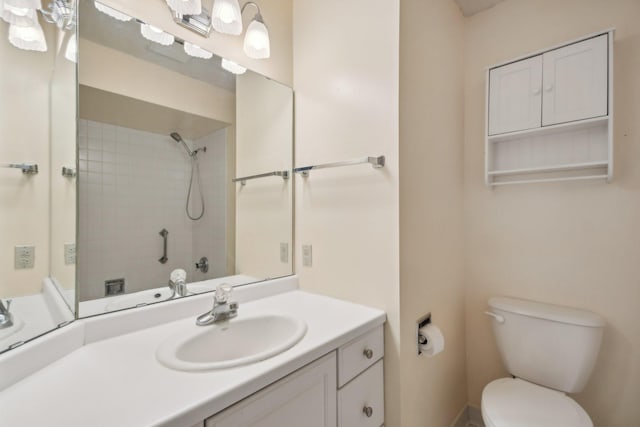 bathroom with toilet, walk in shower, and vanity