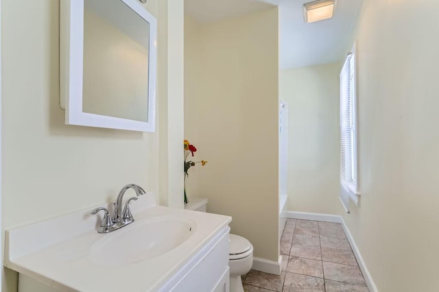 bathroom with baseboards, toilet,  shower combination, tile patterned flooring, and vanity