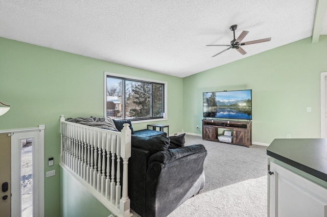 living room featuring lofted ceiling, light colored carpet, a textured ceiling, and baseboards