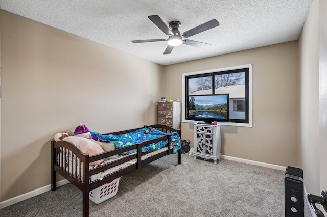 carpeted bedroom with a ceiling fan, baseboards, and a textured ceiling