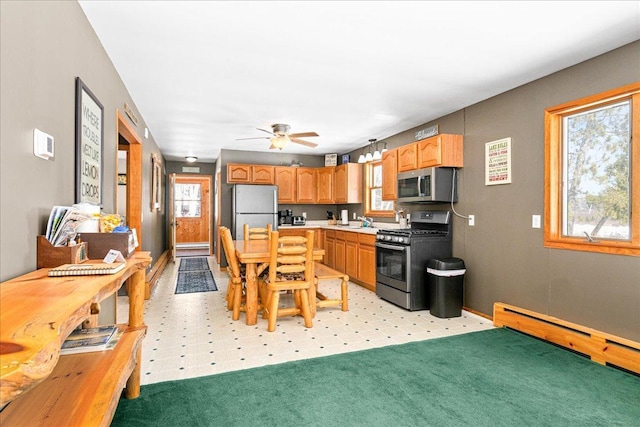 43240 County Highway D, Namakagon Twp, WI 54821 - kitchen with appliances with stainless steel finishes, light countertops, a baseboard radiator, and a ceiling fan