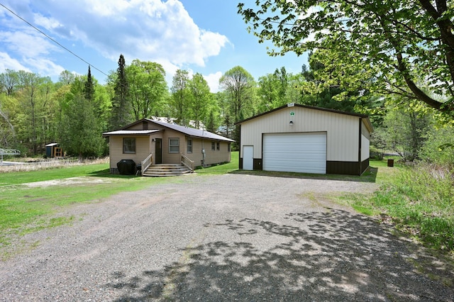 43240 County Highway D, Namakagon Twp, WI 54821 - view of front of property featuring an outdoor structure, a detached garage, and a front yard