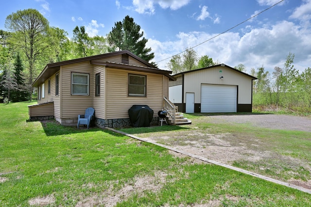 43240 County Highway D, Namakagon Twp, WI 54821 - view of front of property with a detached garage, an outdoor structure, driveway, and a front lawn