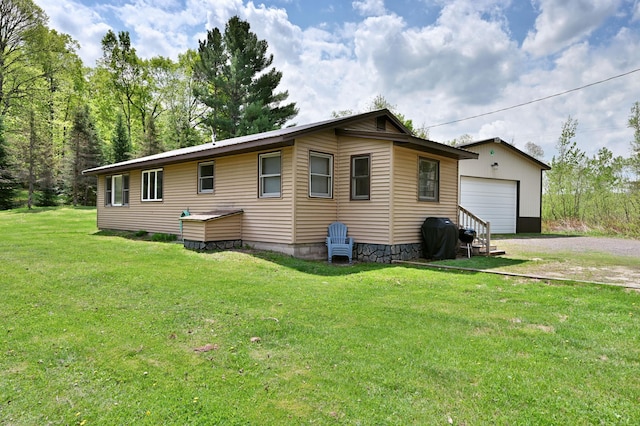43240 County Highway D, Namakagon Twp, WI 54821 - view of home's exterior with a lawn, an outbuilding, driveway, and a detached garage