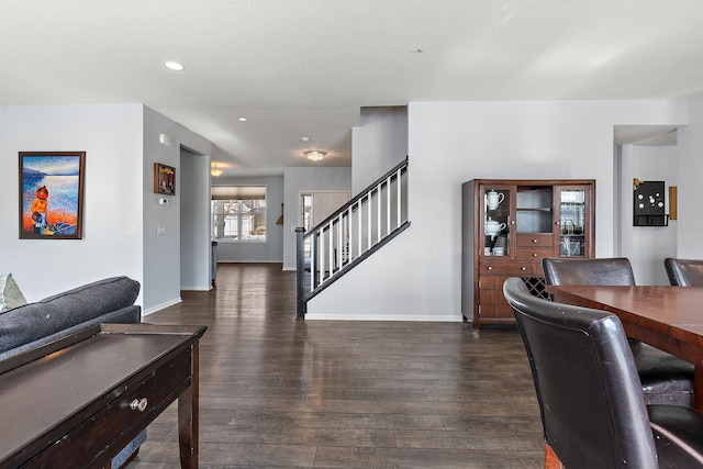 living area featuring stairway, recessed lighting, dark wood finished floors, and baseboards