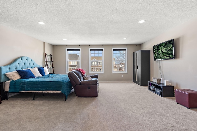 carpeted bedroom with baseboards, a textured ceiling, and recessed lighting