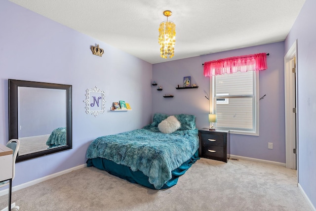 bedroom with carpet flooring, a textured ceiling, and baseboards