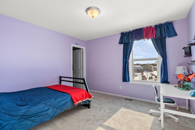 carpeted bedroom featuring baseboards