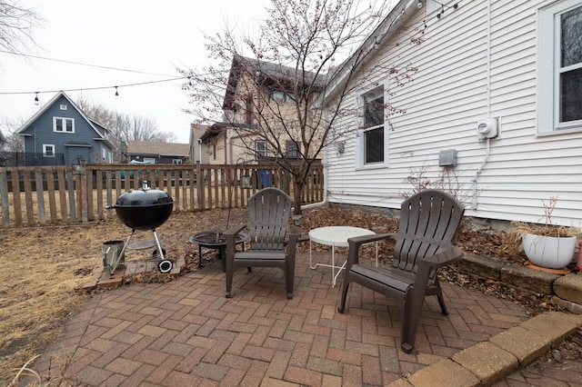 view of patio with a grill and fence