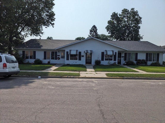 ranch-style home with a front lawn