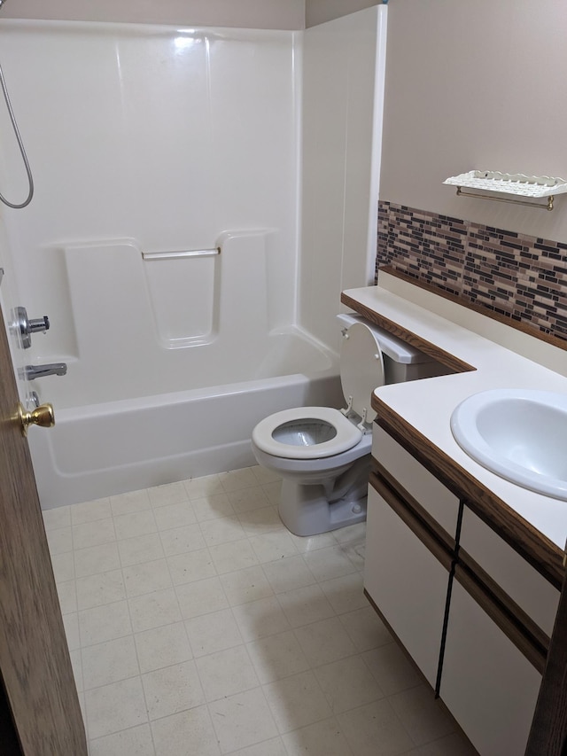 full bathroom featuring toilet, tasteful backsplash,  shower combination, and vanity