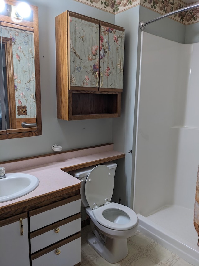 full bathroom with toilet, a shower stall, and vanity