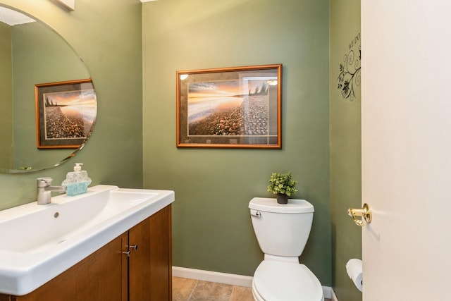 bathroom featuring tile patterned floors, baseboards, vanity, and toilet