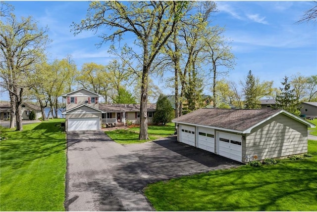 tri-level home with a garage and a front yard