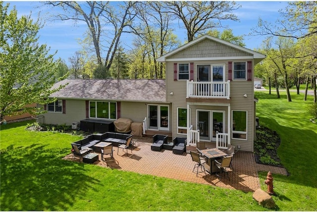 rear view of house with an outdoor hangout area, a yard, a patio area, and a balcony