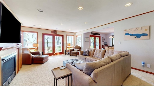 living area featuring plenty of natural light, a fireplace, and light colored carpet