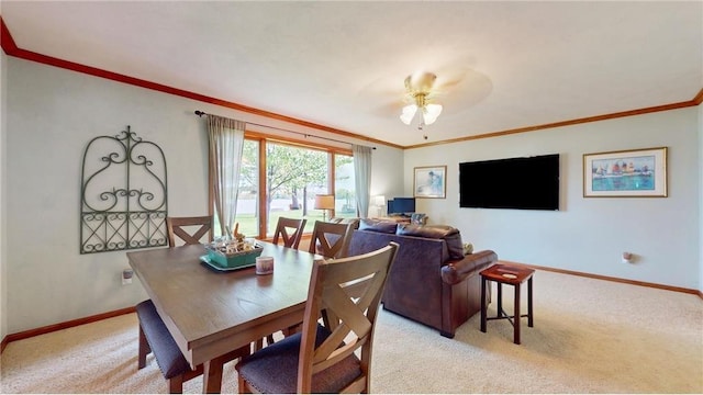 dining area featuring baseboards, ceiling fan, ornamental molding, and light colored carpet