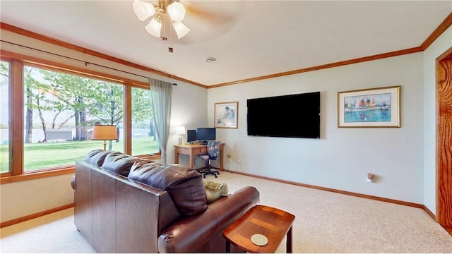 living area with light carpet, a ceiling fan, baseboards, and crown molding