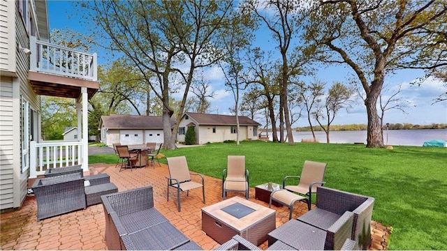 view of patio with a water view, an outdoor living space, and an outdoor structure