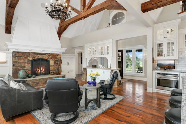 living room with dark wood-style floors, high vaulted ceiling, a fireplace, and beam ceiling