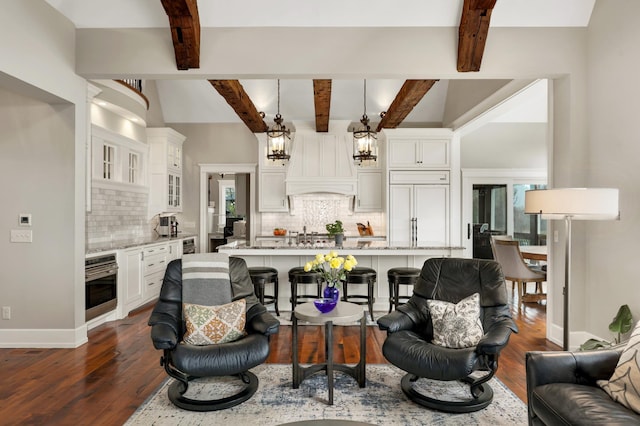 living area featuring dark wood-style flooring, beam ceiling, and baseboards