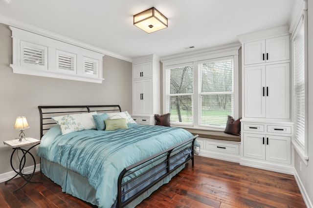 bedroom with ornamental molding, dark wood finished floors, visible vents, and baseboards