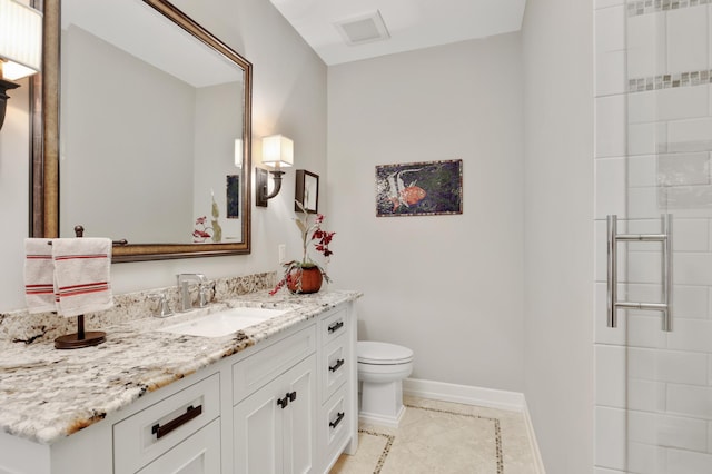 bathroom featuring toilet, visible vents, vanity, baseboards, and tile patterned floors