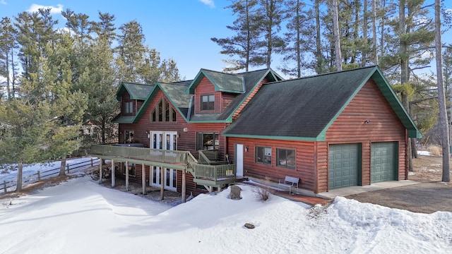 rustic home featuring a deck, a detached garage, and french doors