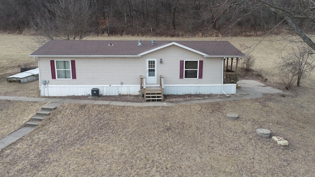 manufactured / mobile home with central AC and a shingled roof