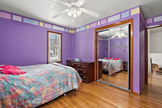 bedroom featuring ceiling fan, a closet, and wood finished floors