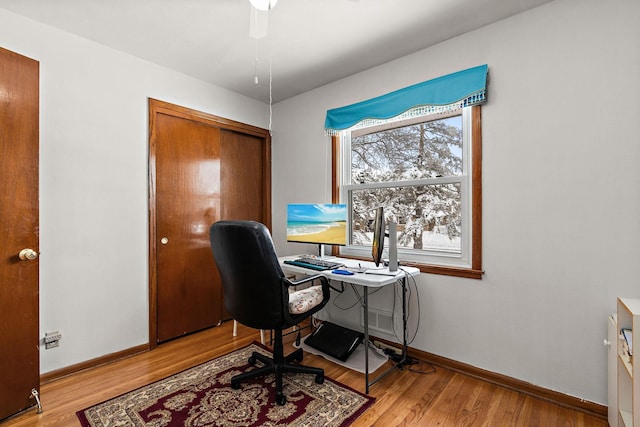 office space with baseboards and wood finished floors