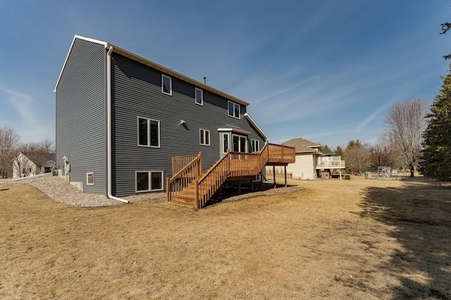 rear view of property featuring stairway and a wooden deck