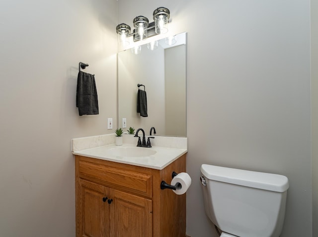 half bathroom featuring toilet and vanity