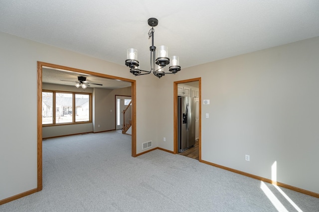 2511 Mayowood Ln SW, Rochester, MN 55902 - unfurnished room with a chandelier, light colored carpet, baseboards, stairs, and a ceiling fan
