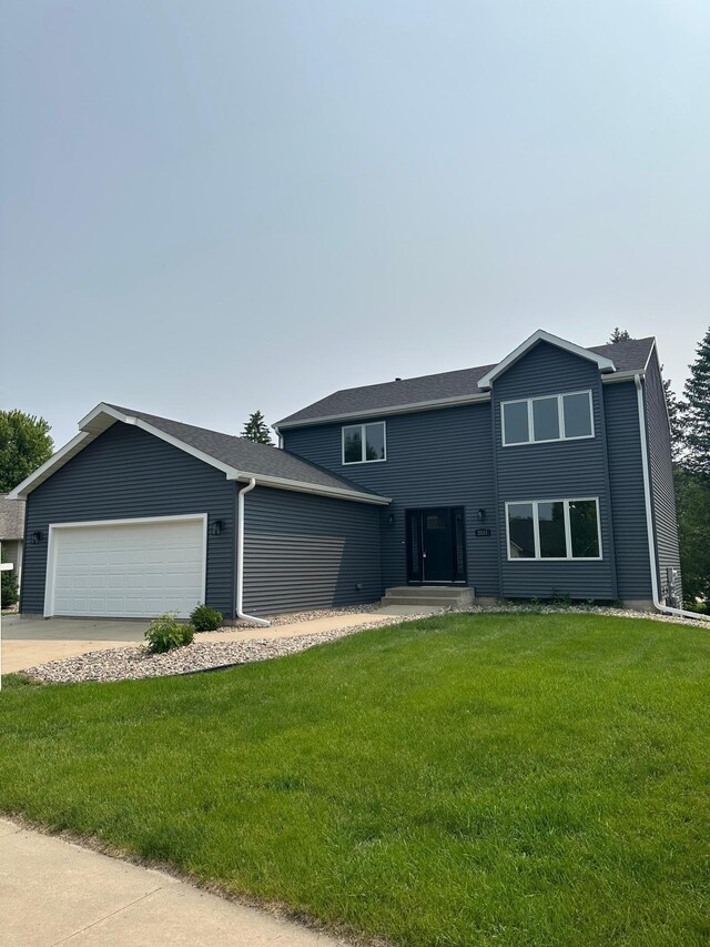 2511 Mayowood Ln SW, Rochester, MN 55902 - view of front of property with an attached garage, a front lawn, and driveway