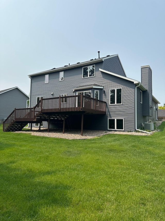 2511 Mayowood Ln SW, Rochester, MN 55902 - rear view of property with a wooden deck, central air condition unit, a chimney, and a yard