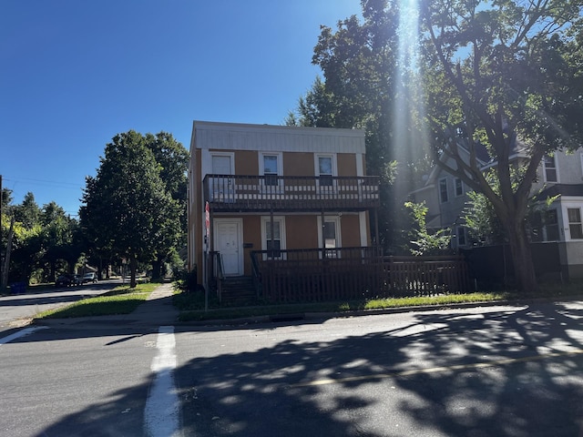 townhome / multi-family property featuring fence and a balcony