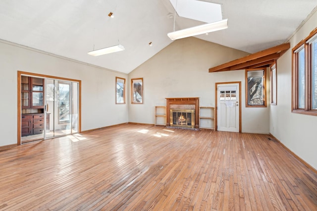 unfurnished living room featuring high vaulted ceiling, a fireplace, and light wood-style flooring