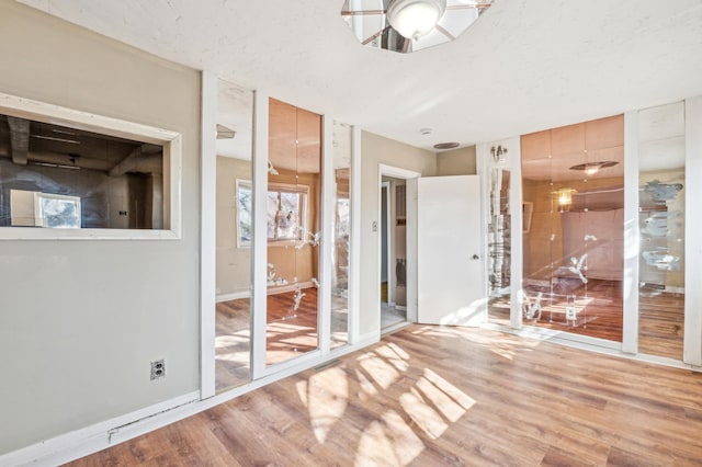 spare room featuring light wood-style floors and a ceiling fan