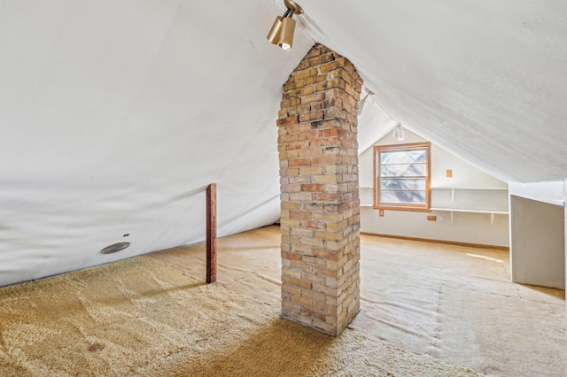 bonus room with lofted ceiling and carpet