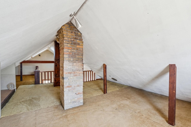 additional living space featuring lofted ceiling