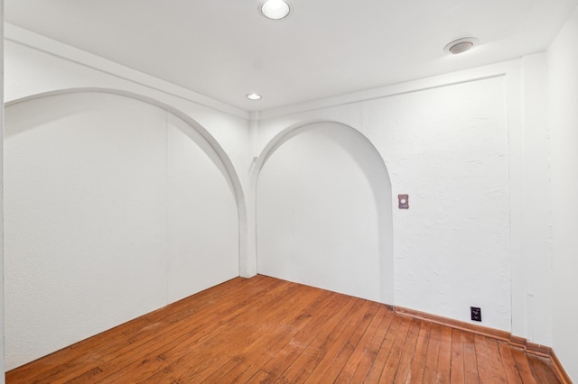 spare room featuring hardwood / wood-style flooring and recessed lighting