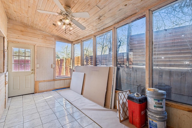 sunroom featuring lofted ceiling, wooden ceiling, and a ceiling fan