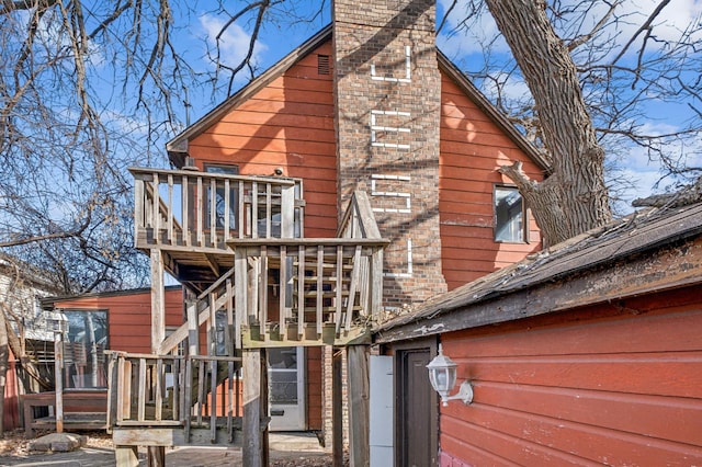 back of property with a chimney and a playground