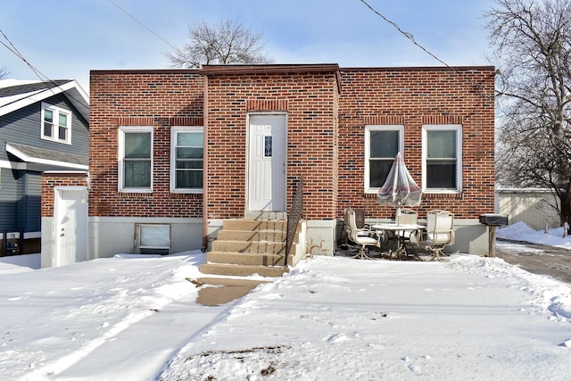 view of front of house with entry steps and brick siding