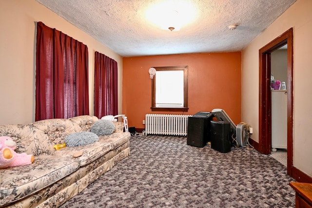 interior space featuring carpet floors, radiator, a textured ceiling, and baseboards