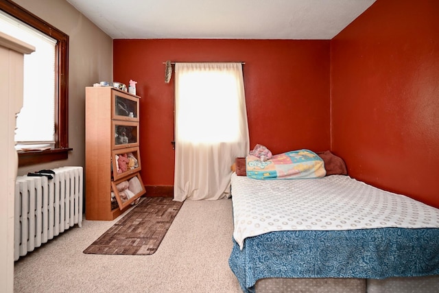 carpeted bedroom featuring radiator