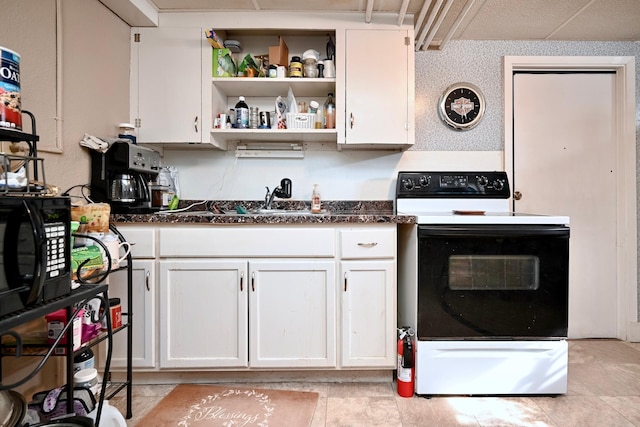 kitchen featuring open shelves, black microwave, range with electric cooktop, and white cabinets